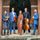 Here on Earth A group of people posing for a picture with violins.