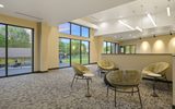 A room with chairs overlooking the venue through windows.